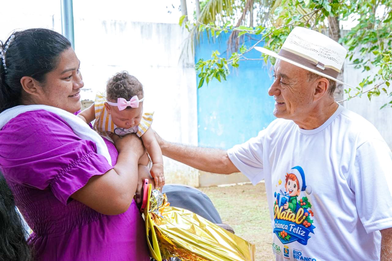 Foto do prefeito Bocalom entregando o presente para uma criança